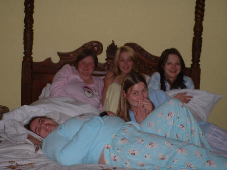 Five young lasses share a bed